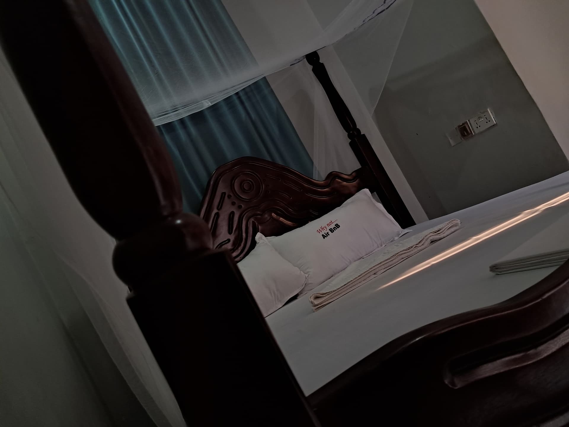 SMK Guest House — cozy bedroom with wooden bed